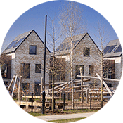 A row of new houses can be seen. There is a playground in front of the houses. 